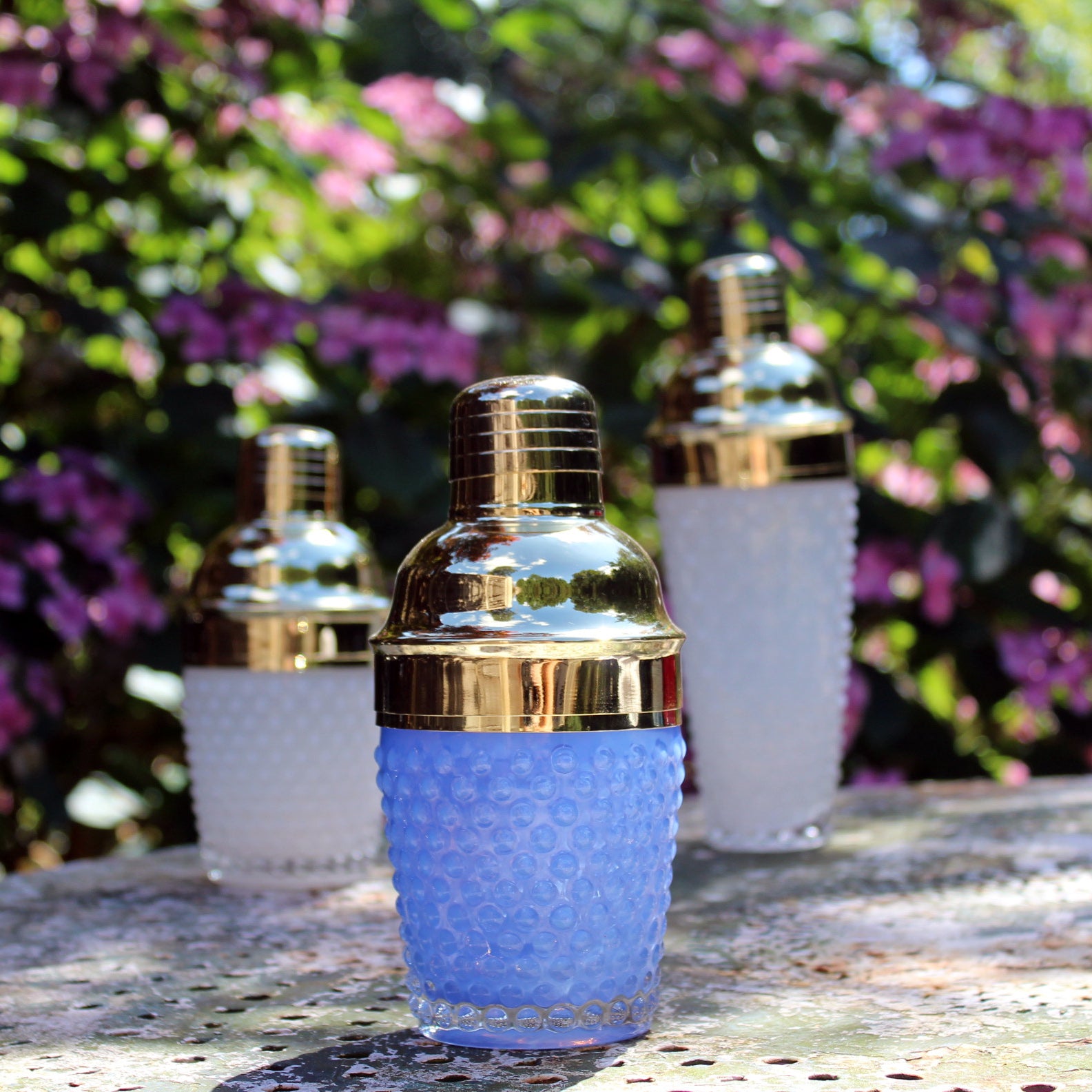 short blue glass cocktail shaker